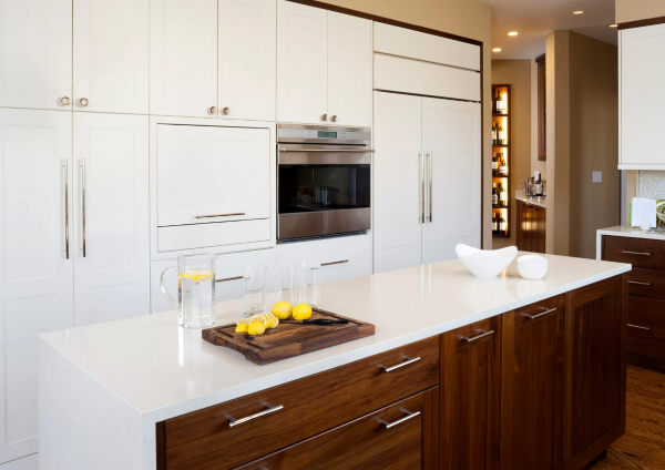 Walnut island in white kitchen