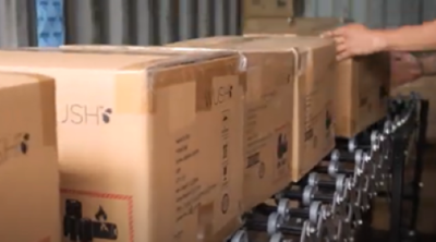 cartons from shipping container on conveyor system