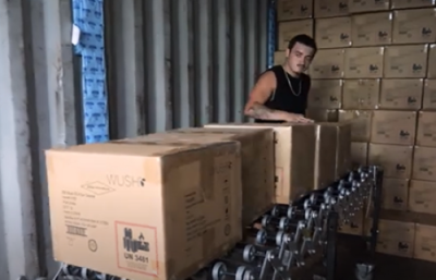 loading cartons onto conveyor from shipping container