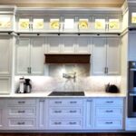 Glass front cabinets in kitchen featuring Brighton Custom Cabinetry